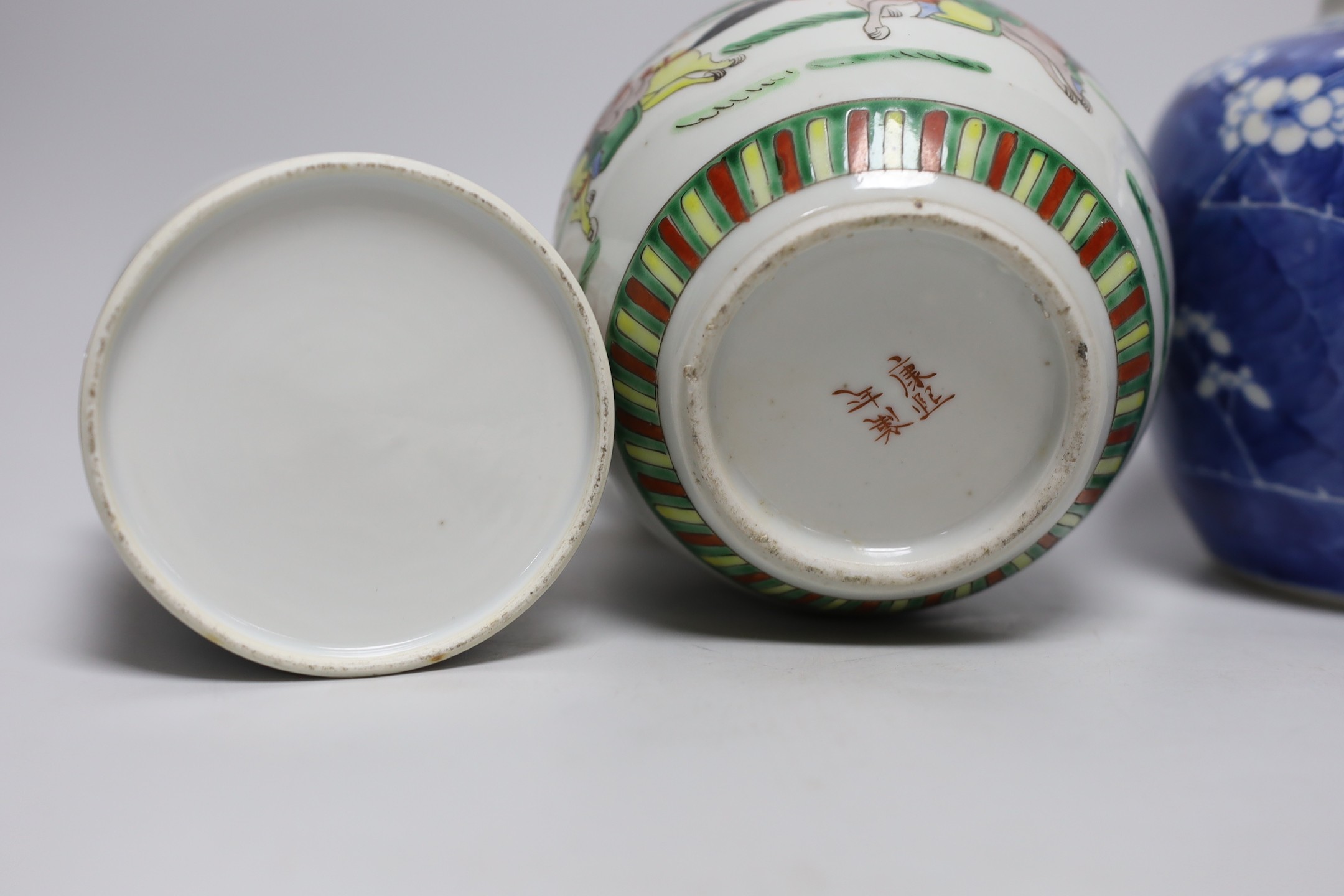 A 19th century Chinese famille rose box and cover, a blue and white prunus jar, two other jars, a figural brush rest and a cloisonne enamel dish